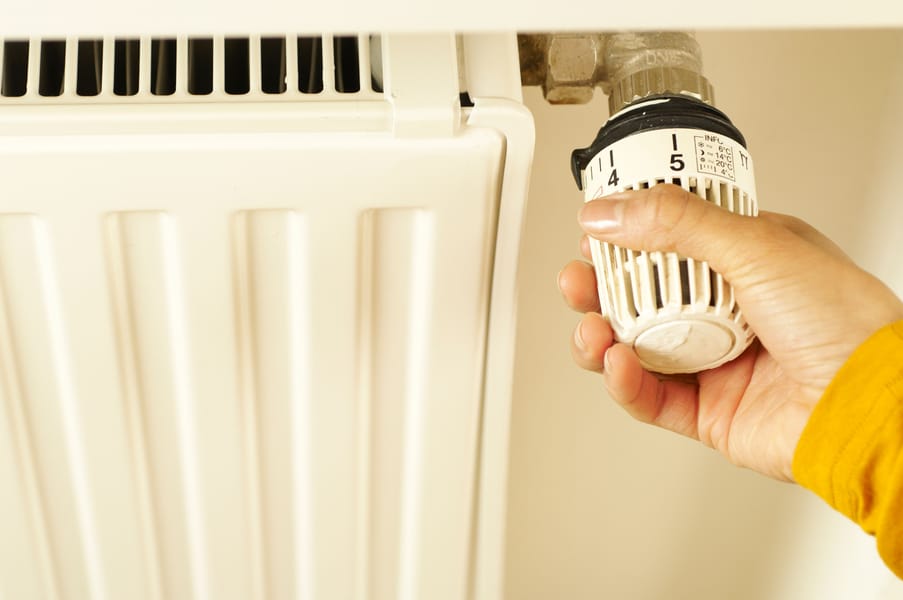 Technician inspecting a furnace, illustrating common furnace problems.