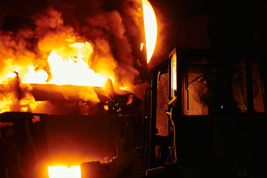 Technician working on a furnace at night, symbolizing emergency furnace repair.